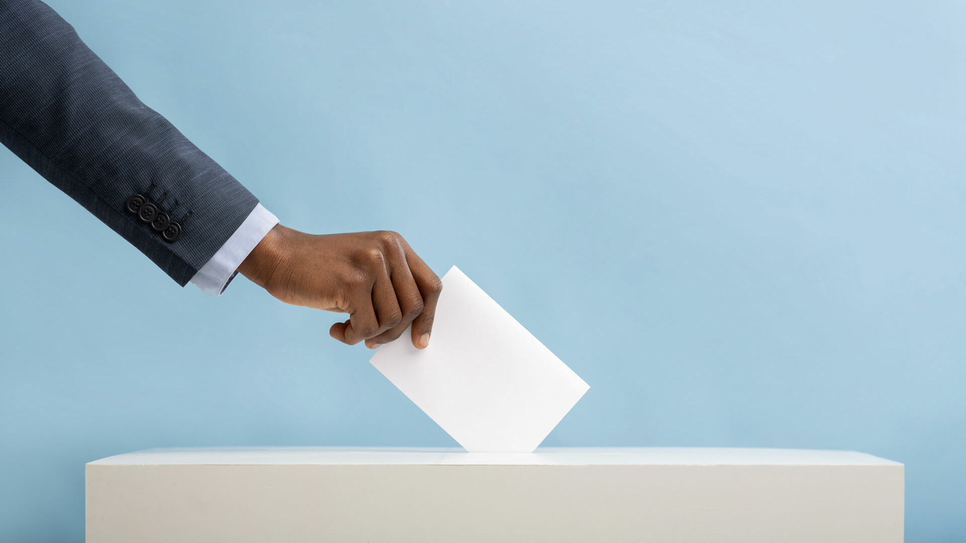 An image of an African man's hand placing a vote in a ballot box | 2022 General Elections in Kenya