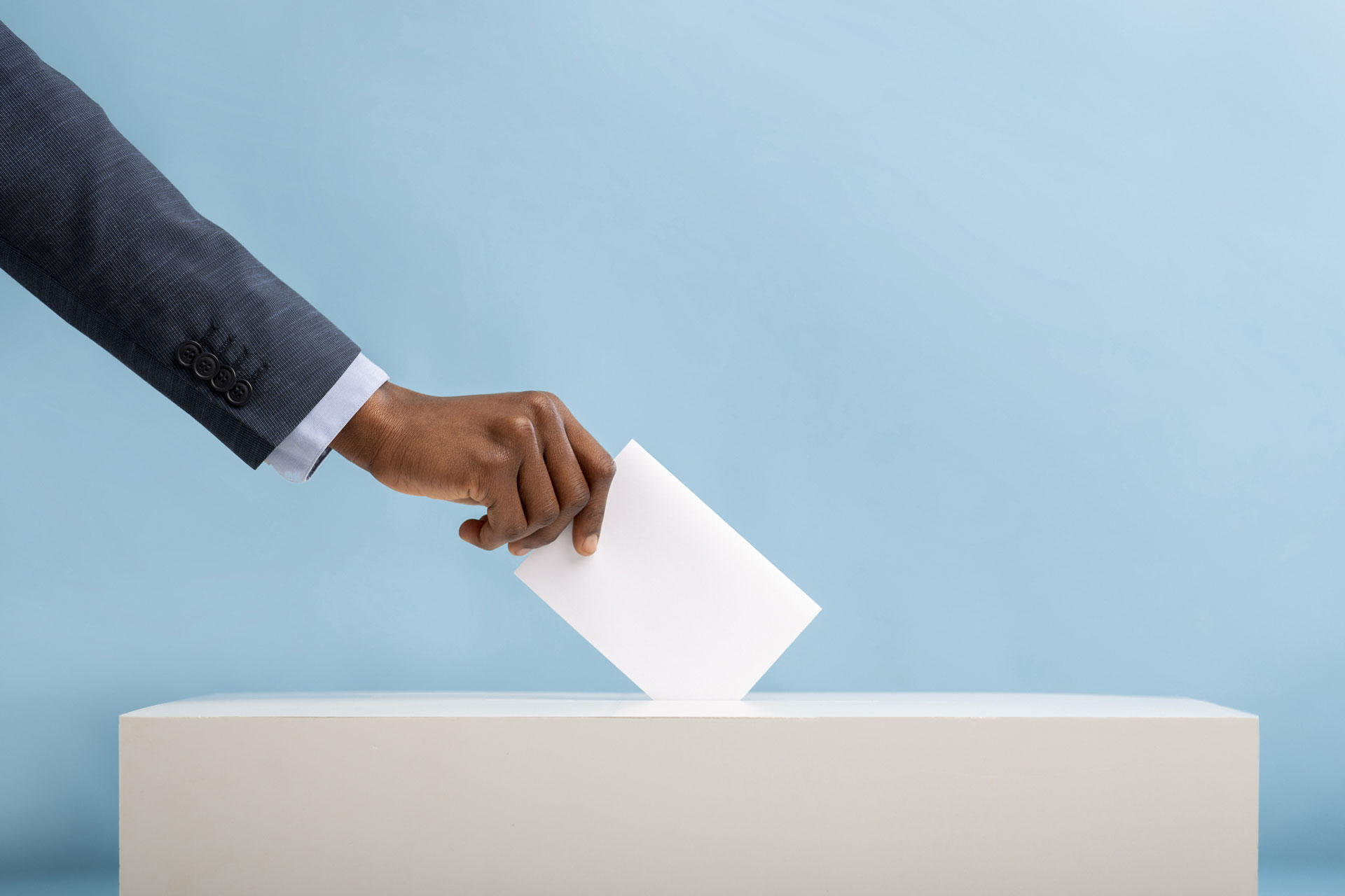 An image of an African man's hand placing a vote in a ballot box | 2022 General Elections in Kenya