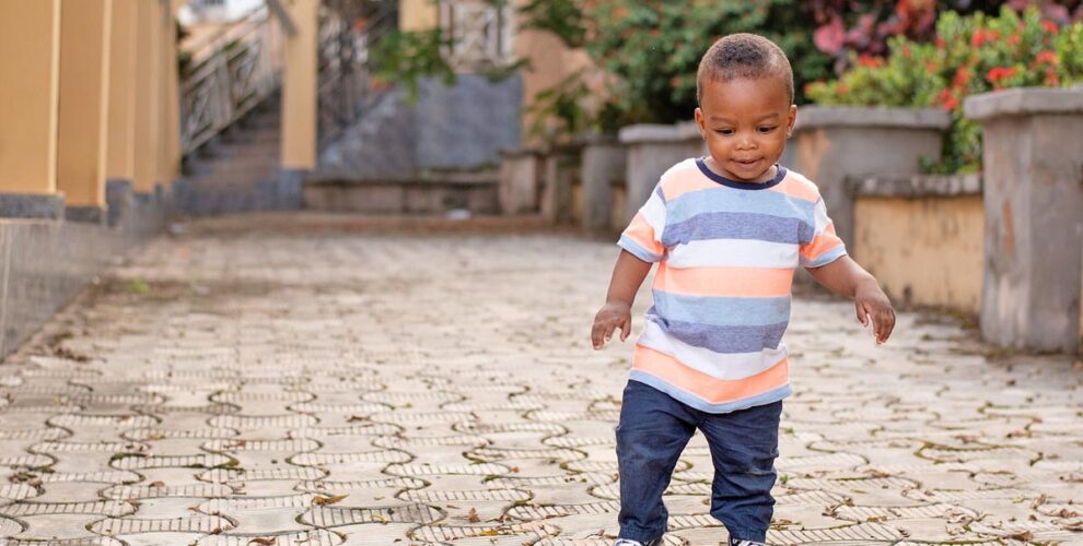 Photo of a young child walking towards the camera. At Imani Montessori, we recognize that movement plays a crucial role in a child’s growth, learning, and self-discovery. By providing an environment that supports freedom of movement, we empower children to explore, learn, and thrive on their unique developmental journey. | Image: Freepik